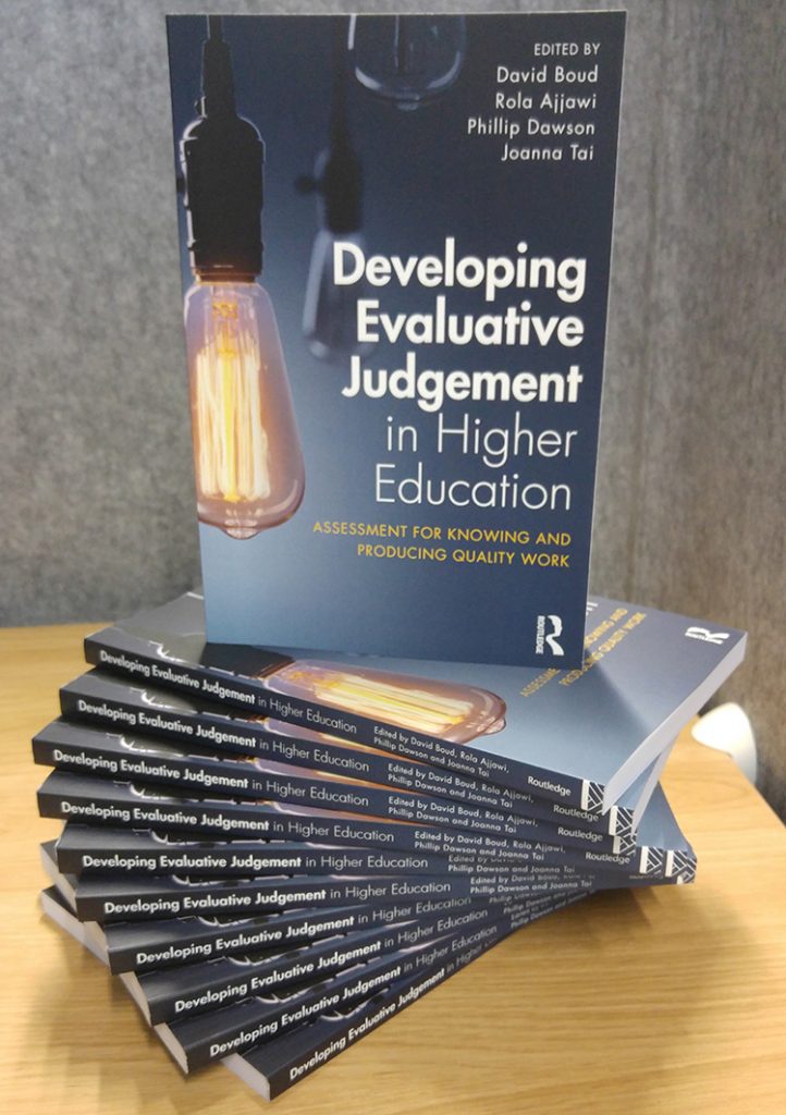 Developing EJ book standing on elegantly swirled stack of books