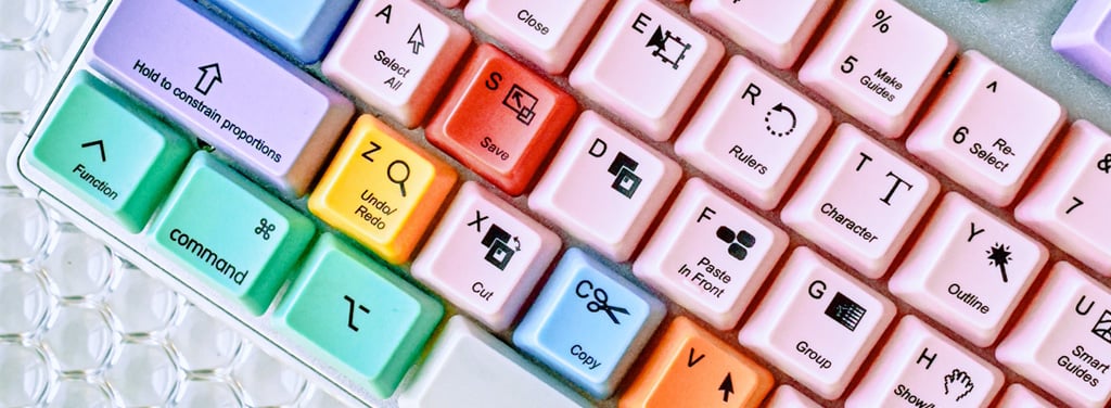 A colourful computer keyboard with computer shortcuts labelled under keyboard letters and buttons
