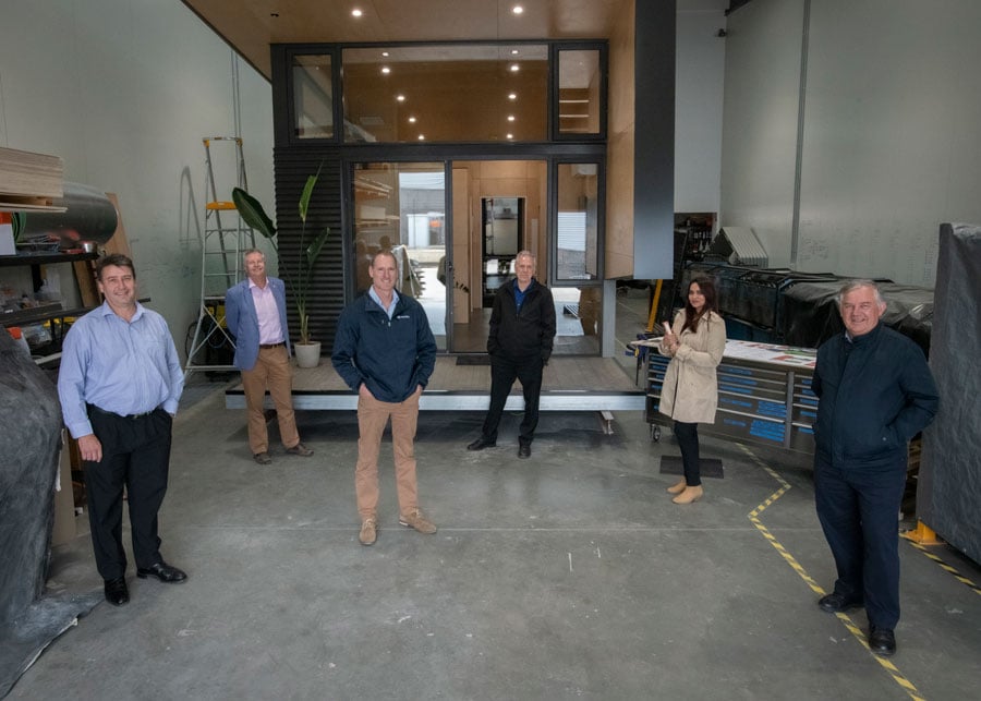 Stakeholders and designers standing in front of FormFlow Prefab21