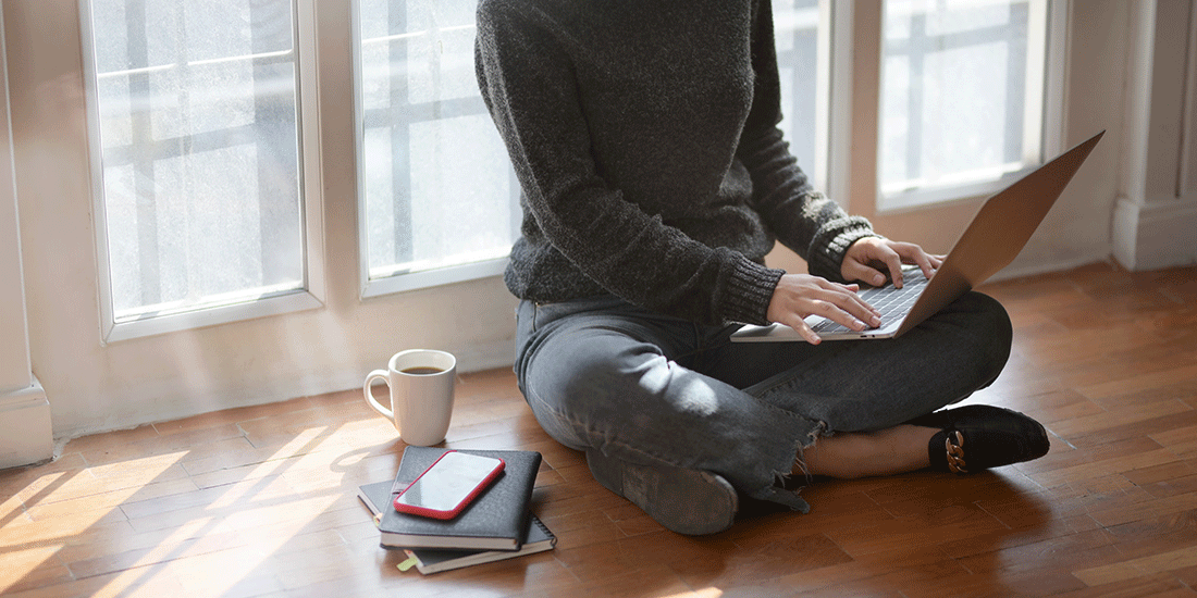 Gartner blog header: woman sitting cross-legged with laptop