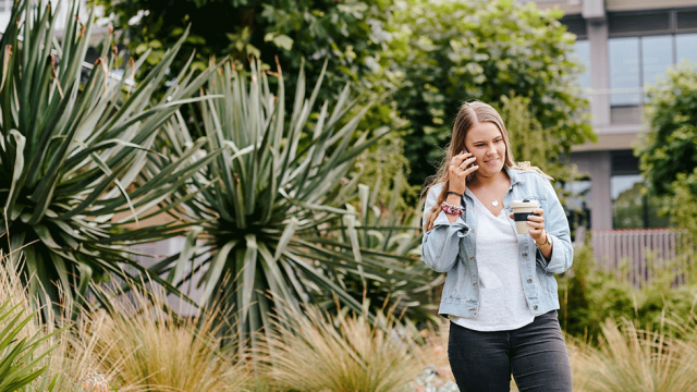 blog header: woman talking on her mobile phone with a smile on her face