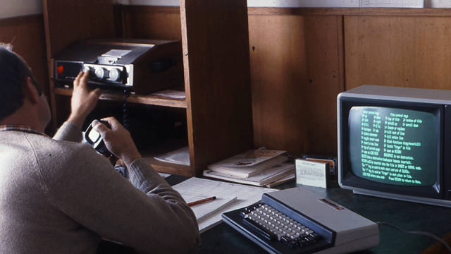 Blog header: picture of man studying on early computer monitor