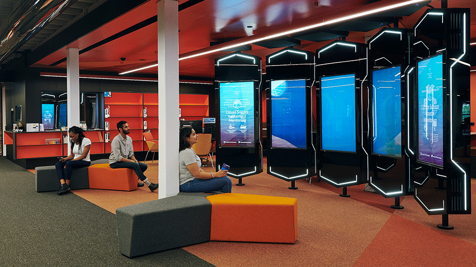 Students viewing the display screens at Waterfront Library