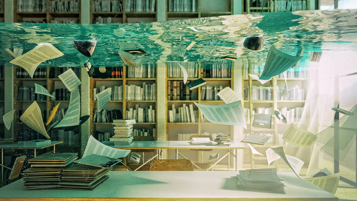 Stock image of water in a library with books and papers floating