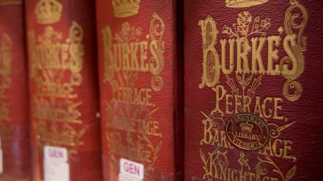 Image of book spines stacked together. Books are dark red with gold lettering and says Burke's peerage
