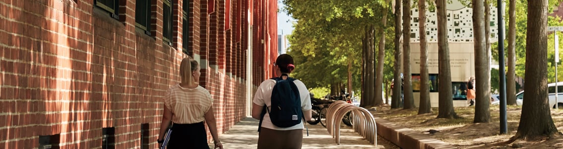 Back view of two students walking at the Waterfront Campus