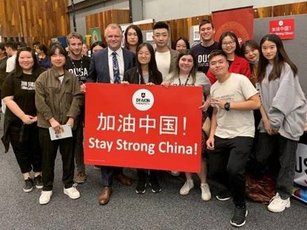 Vice-Chancellor Iain Martin, alongside students and staff, say Stay Strong China