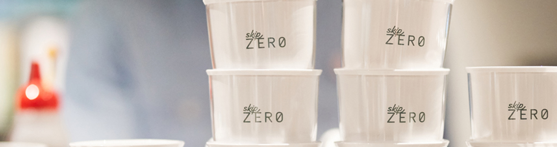 close-up of Skip Zero reusable cups on top of cafe coffee machine