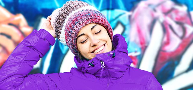 Smiling girl in beanie and purple jacket