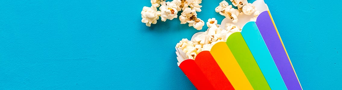 Popcorn spilling out of rainbow-coloured box