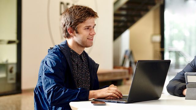 Male student working on laptop
