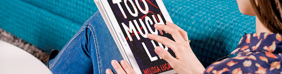 Woman holding copy of Melissa Lucashenko's novel, 'Too much lip'