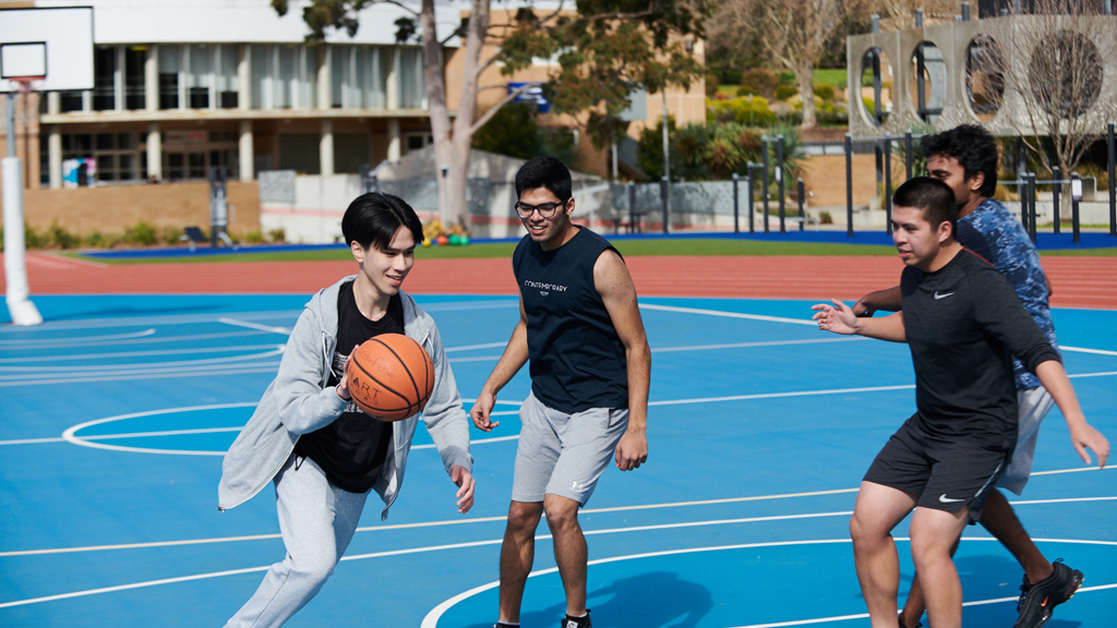 Four students playing basketball outside at Waurn Ponds Campus
