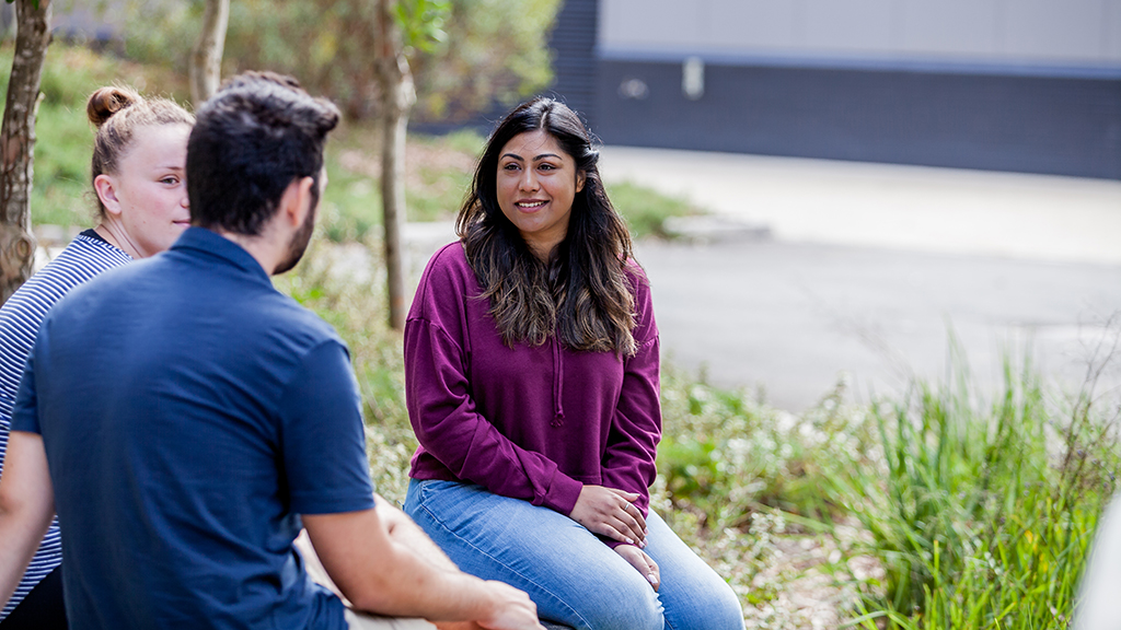 Three students sitting outside at Waurn Ponds Campus