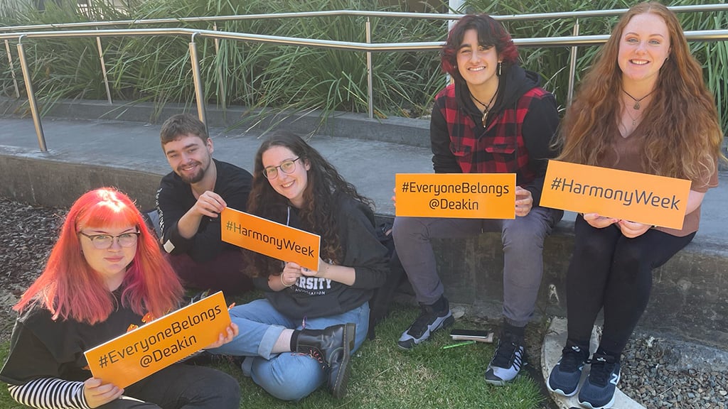 Group of Deakin students holding signs in support of Harmony Day