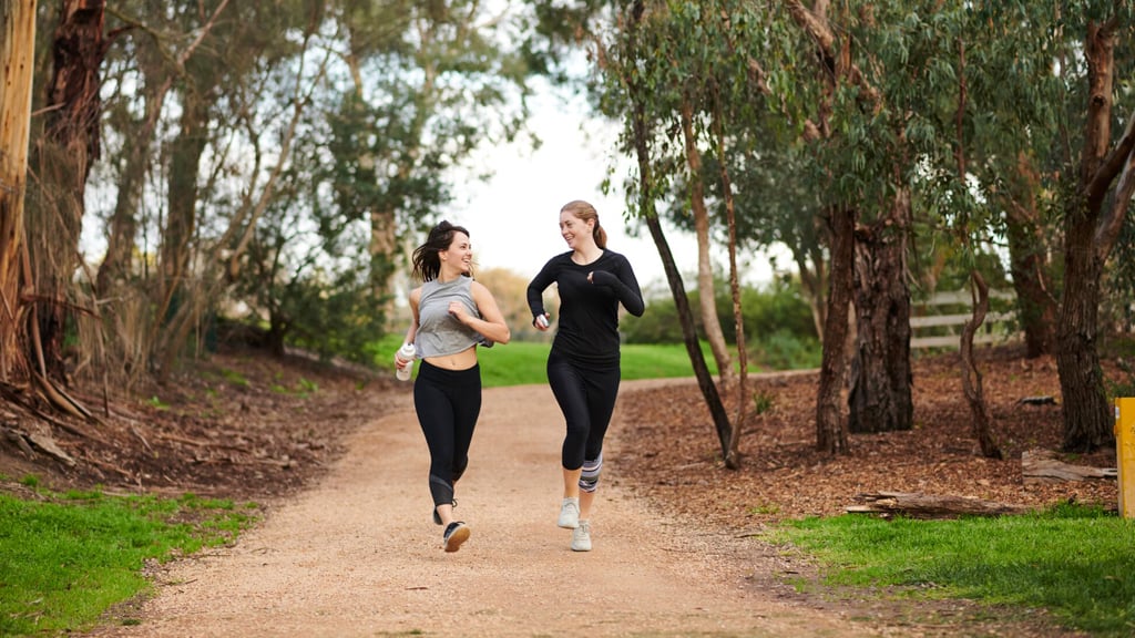 Two students running outside at Burwood Campus