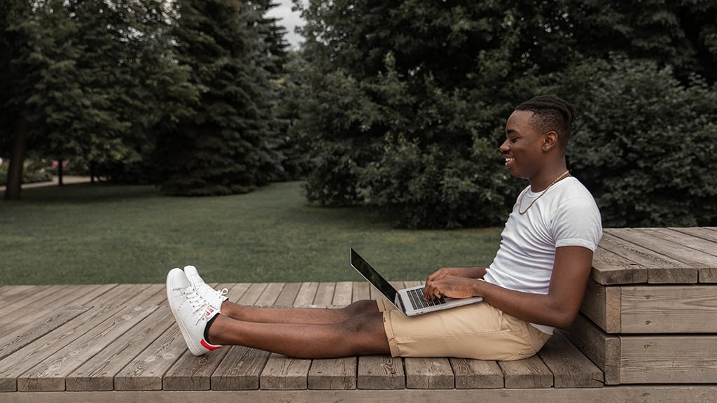 Smiling young man with laptop