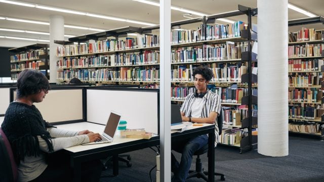 Students working in study desk area of library