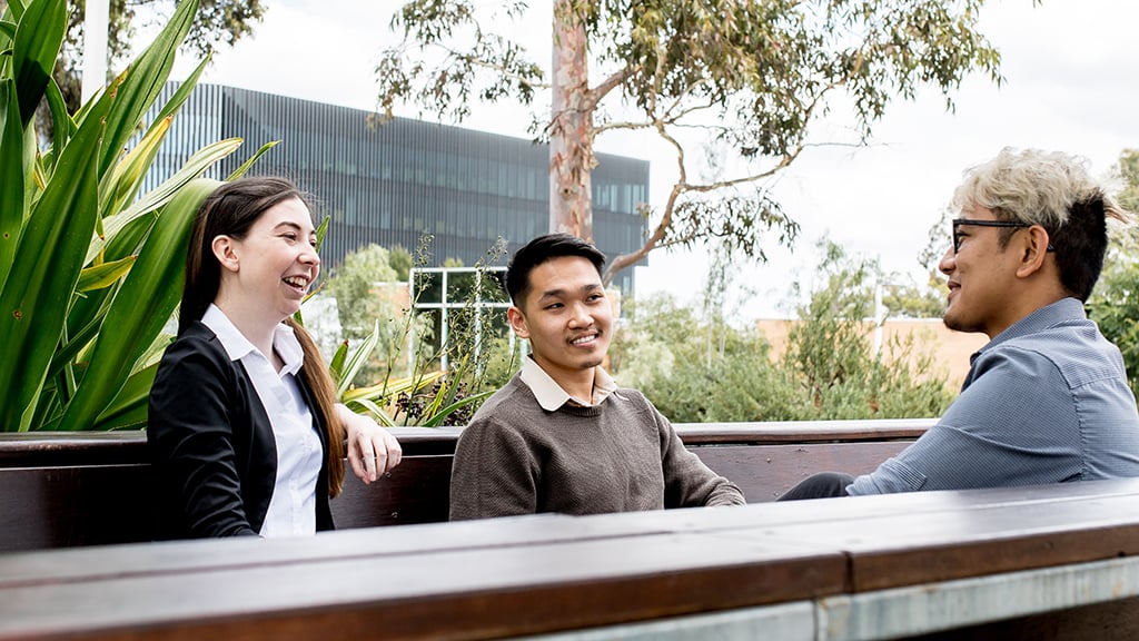 Three students sitting outside at Burwood Campus
