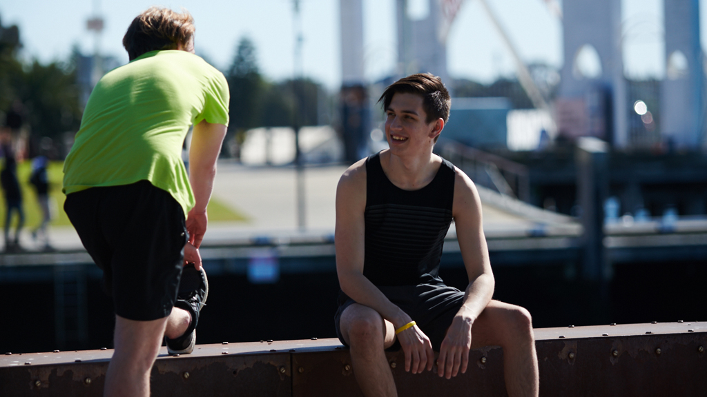 Two students chatting as they cool down after a run at Geelong Waterfront