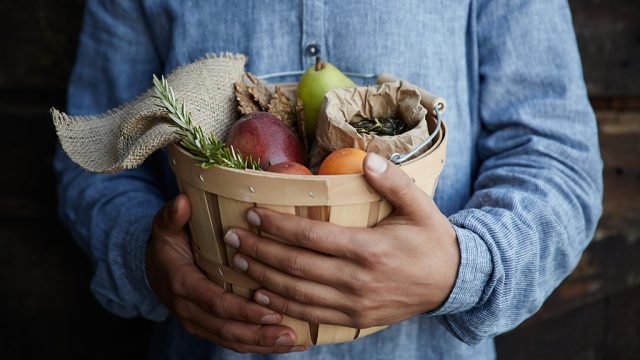 Cropped shot of person holding basket of healthy food