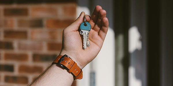 Close-up shot of hand holding house keys