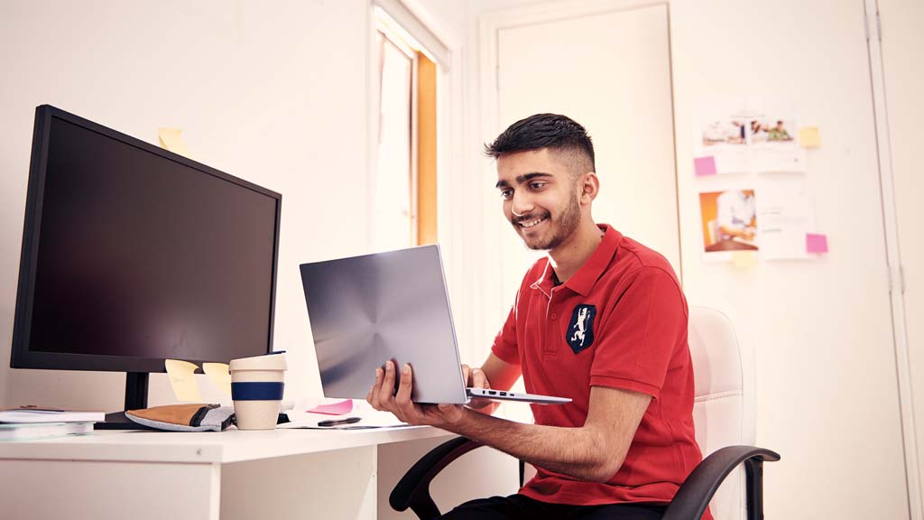 Student working on laptop from home