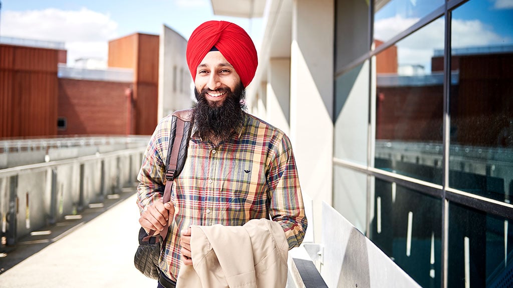 Smiling male student in turban on campus