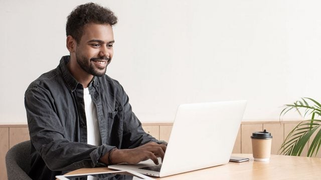 Smiling male with laptop