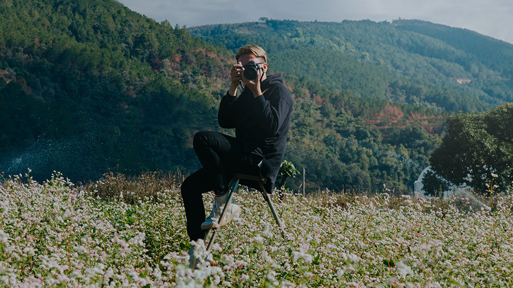 Male taking photograph in nature