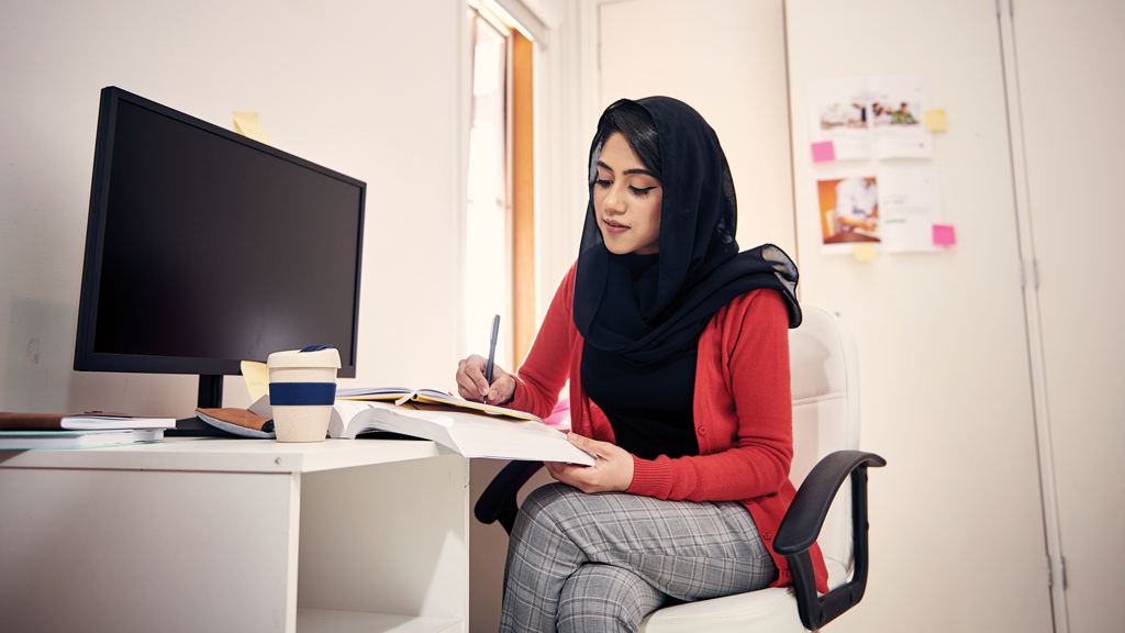 Woman studying at desk in home office