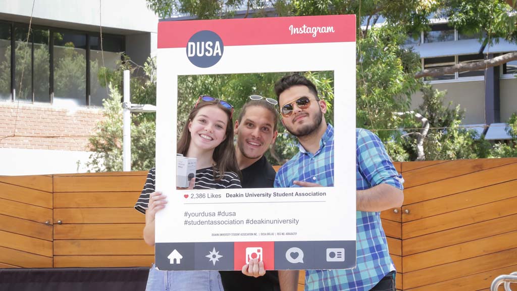 Three students posing for photo at DUSA OFest event