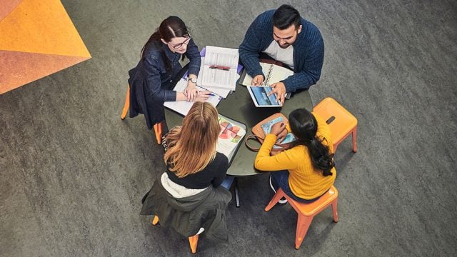 Aerial shot of four students studying together on campus