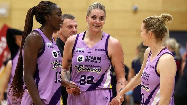Melbourne Boomers players Ezi Magbegor and Cayla George celebrate her 300th WNBL games with a teammate