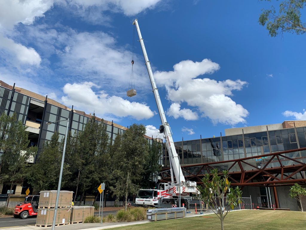 Cranes installing solar panels at Burwood Campus