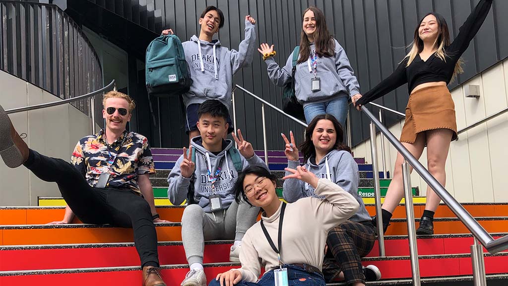 Students show off their DUSA gear on the coloured steps at Burwood Campus
