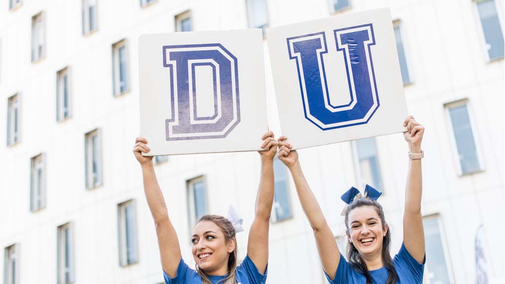 Deakin University cheerleaders holding up D and U placards