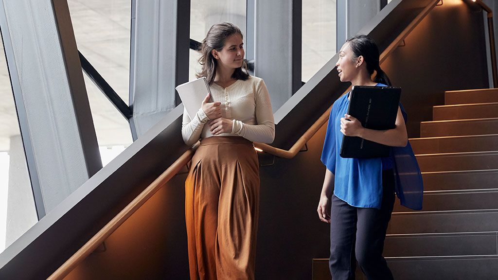 Two female students on staircase