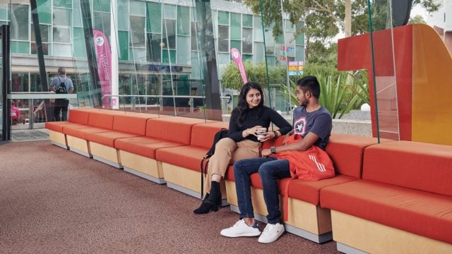 Two students sitting together and chatting at Burwood Campus