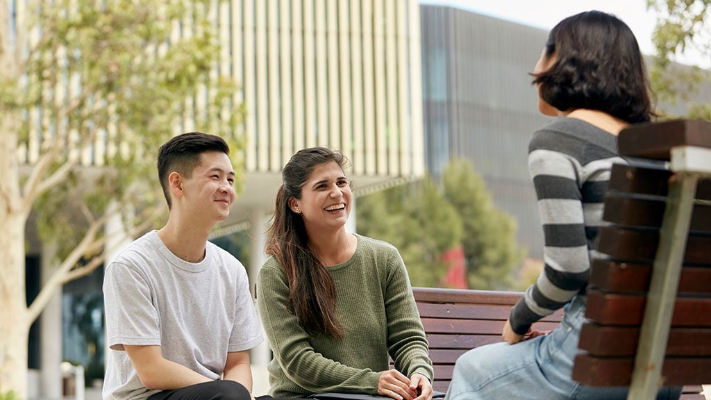 Three students chatting outside at Burwood Campus