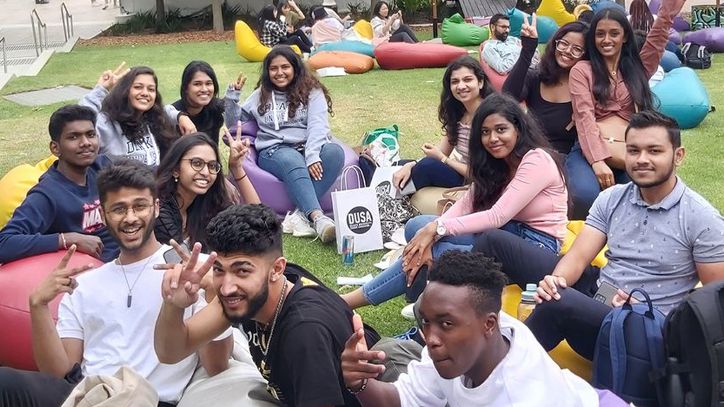 Students gathered on lawn at DUSA on-campus event