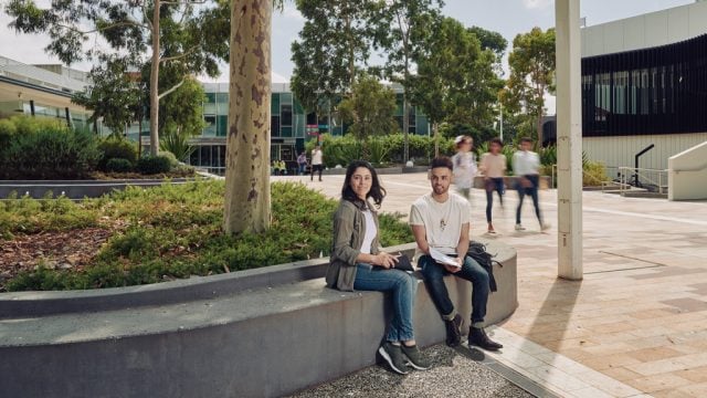 Two students sitting together outside at Burwood Campus