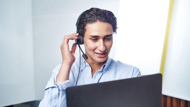 Male student with laptop and headset