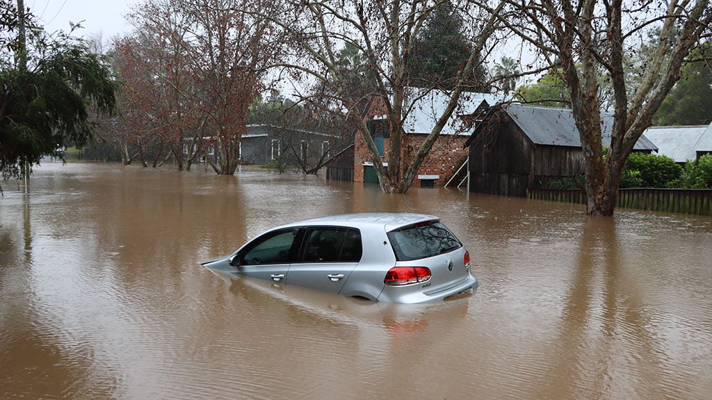 Car partially submerged in floodwater