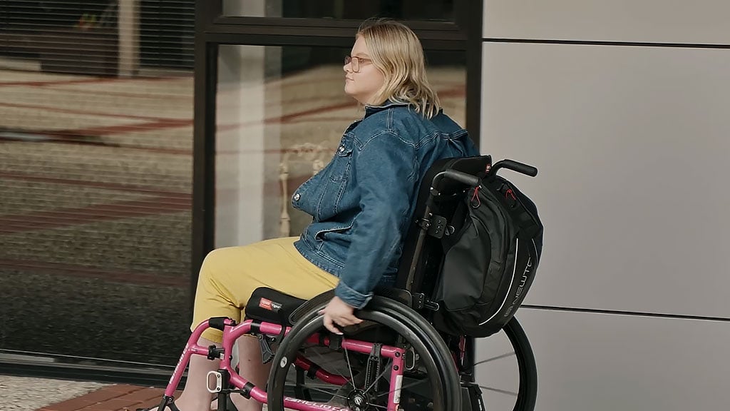 Deakin student Kyra on campus in wheelchair