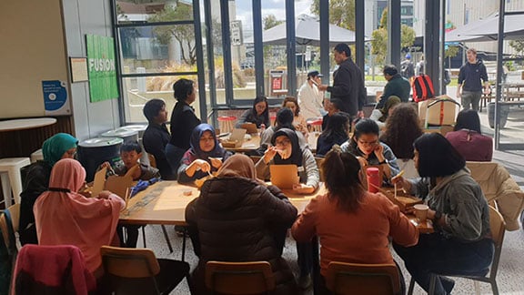 Group of international students eating at Winter Garden