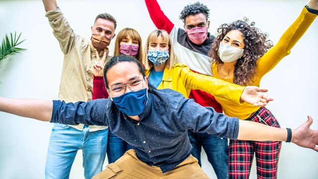 Group of young adults wearing masks