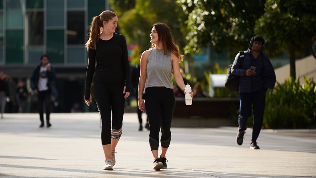 Two students chatting together on Morgan's Walk at Burwood Campus