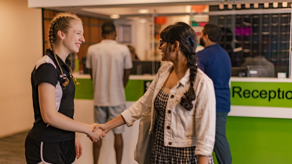 Res Leader greeting a student at a campus accommodation facility