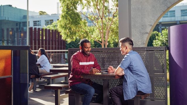 Two students sitting outside at Waurn Ponds Campus